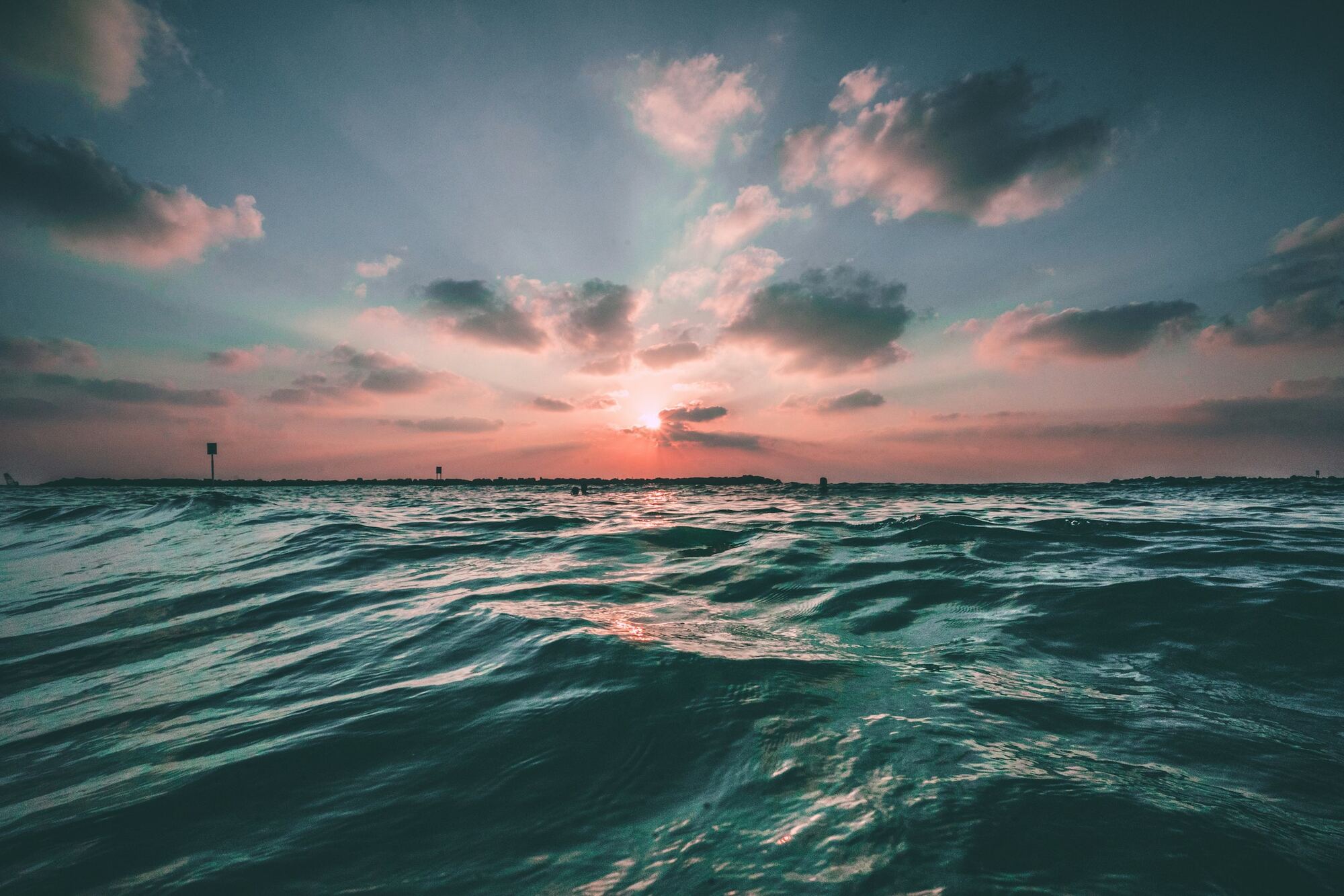 Sunset over a gently rippling open sea